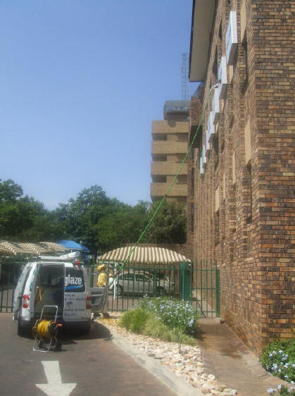 Cleaning high mounted signage at Kelly Girl